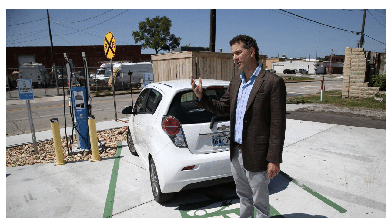 David Jankowsky with electric car and charging station