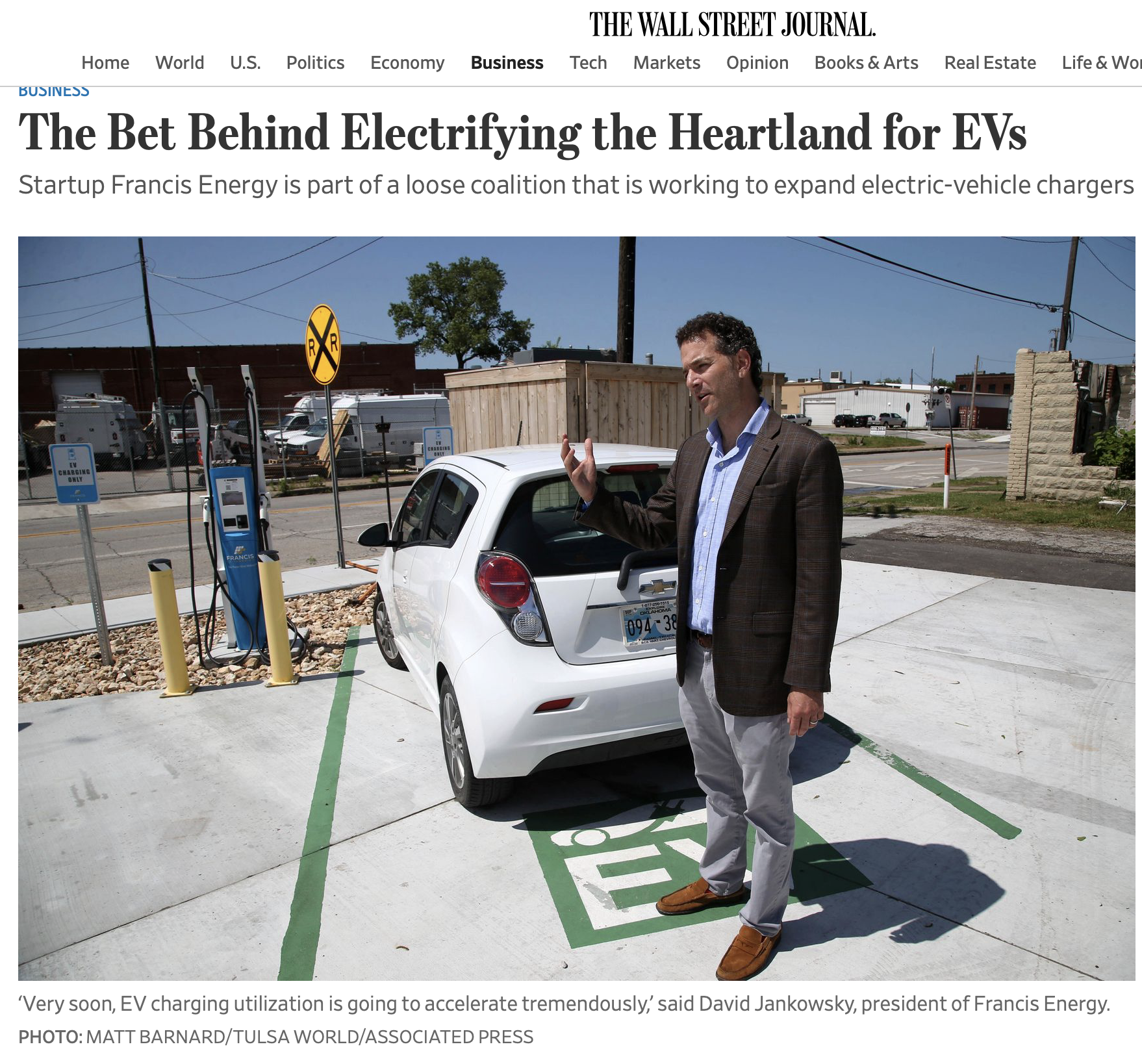 David Jankowsky with electric car and charging station